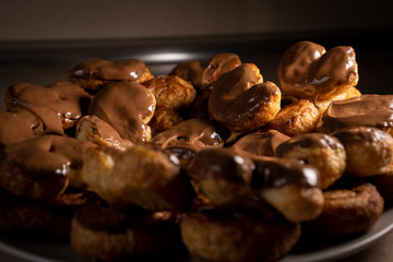 Chocolate palmier biscuits on a plate. Heart-shaped puff pastry, pig's ear, palm leaves cookies, elephant ears, french hearts, shoe-soles.
