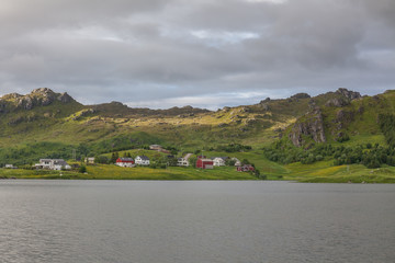 Fototapeta premium Typical Norwegian fishing village with traditional red rorbu huts, Reine, Lofoten Islands, Norway