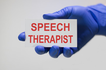 Speech therapist text on card and hand holding it. Medicine concept.