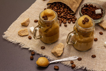 Dalgona coffee in mason jar. Korean fluffy whipped coffee beverage