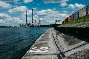 Quayside with the water and view of factory with chimneys