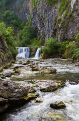 Mountain river with waterfall in summer time