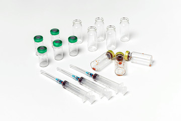 Clean and used medical vials, hypodermic syringes isolated on white background. Treatment, cure...