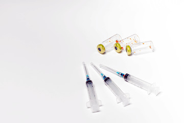 Used medical vials and hypodermic syringes isolated on white background. Treatment, cure background, copy space