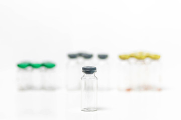 Close-up of clean and empty medical vials with caps isolated on white background. Samples, medical bottles