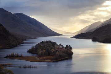 Landscape with famous Scottish lake Loch Shiel and an island in the middle of it on sunset, Scotland.