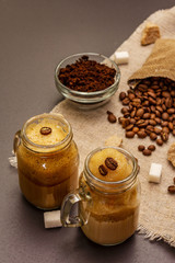 Dalgona coffee in mason jar. Korean fluffy whipped coffee beverage