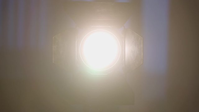 Footage of studio light being turned on and off. Floodlight flashes
