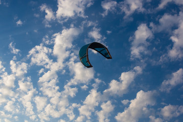 kitesurfer rides a kite-surf on waves of the sea