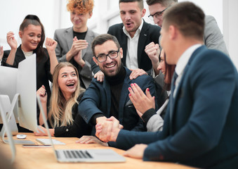 happy business colleagues shaking hands with each other.