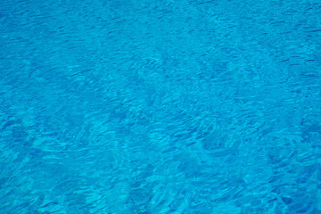 Fototapeta na wymiar Blue and crystalline water of a swimming pool
