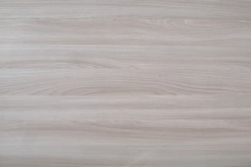 Laminated panel with light wood texture, background.