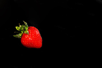 Fresh strawberries on a black background.