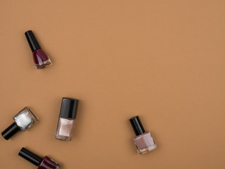 The nail polishes. Beige background. The concept of the manicure.