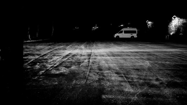 Van Parked In Parking Lot At Night