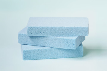Blue pumice stone foot scrubbers on blue background