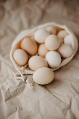 Farm eggs in eco natural bag on craft paper background.