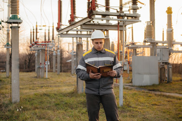 The energy engineer inspects the equipment of the substation. Power engineering. Industry
