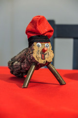 Wooden toy, Tió de Nadal, on table with red towel, Barcelona, Spain