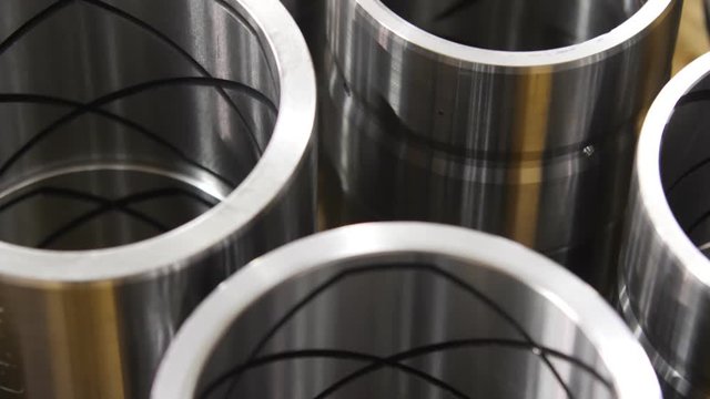 Metal parts are in warehouse after production. bushings for excavators. Grooves for lubrication.