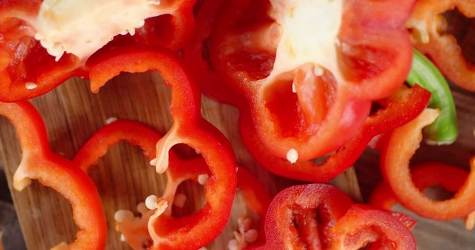 Pieces of fresh sweet peppers slowly rotate.