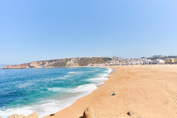 Fototapeta na wymiar Summer morning at beach of Nazaré in Portugal