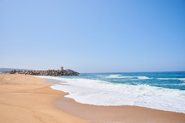 Summer morning at beach of Nazaré in Portugal