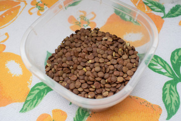 brown lentils lying in a bowl, close-up