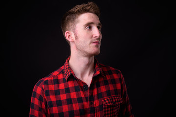 Face of young handsome hipster man thinking