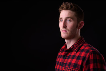 Face of young handsome hipster man thinking