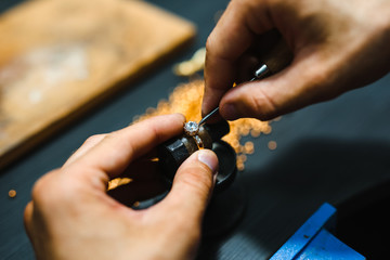 Master goldsmith working at golden ring.  Jewelry, craft, handmade industry concept . - obrazy, fototapety, plakaty