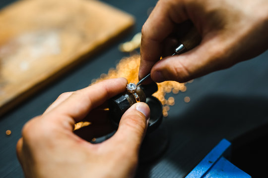 Master goldsmith working at golden ring.  Jewelry, craft, handmade industry concept .