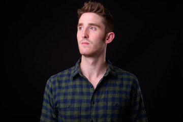 Face of young handsome hipster man thinking