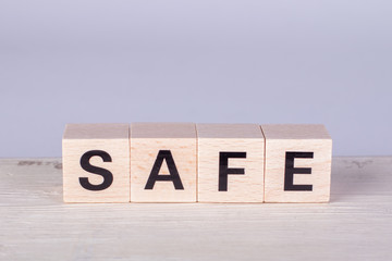 wooden cubes building the word Safe, white background