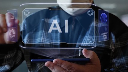 Unrecognizable elderly man in a protective mask interacts with HUD holograms on a smartphone with text AI. Old man in a plaid shirt with a holographic screen on a blurred background - Powered by Adobe