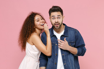 Amazed young couple two friends european guy african american girl in casual clothes posing...