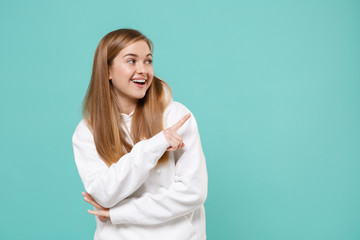 Funny young woman girl in casual white hoodie posing isolated on blue turquoise wall background...