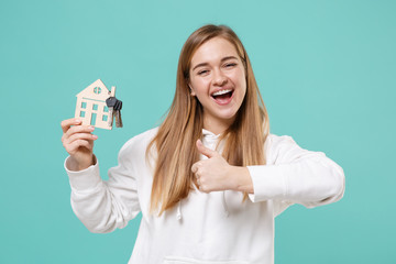 Cheerful young woman girl in casual white hoodie posing isolated on blue turquoise background...