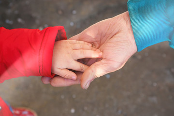 Children's hand in an elderly hand