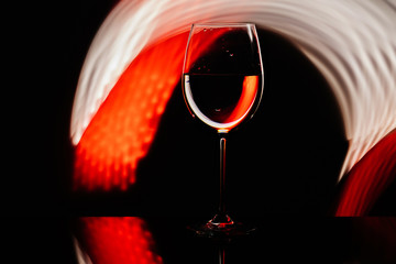 Glass for wine against the backdrop of bright color solutions 