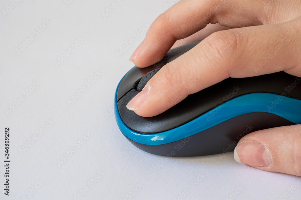 Fototapete Hand on a computer mouse. Work at the computer. Technology concept. Copy space.