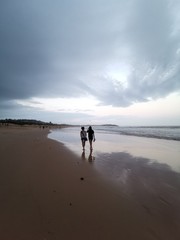 Reflection of two ladies on the Dee Why Beach, Sydney Australia
