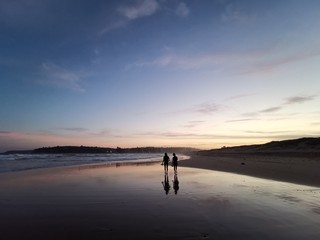 Obraz na płótnie Canvas Reflection of two ladies on the Dee Why Beach, Sydney Australia