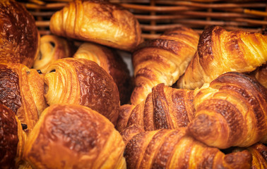 Basket of freshly backed croissants and chocolate croissants