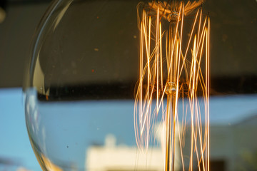 Amazing spiral electric current inside a retro crystal clear light bulb.