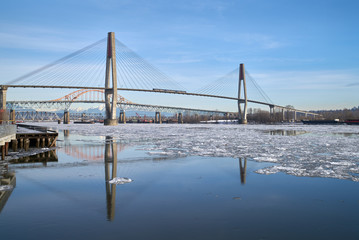 Fraser River Bridges and Winter Ice. Ice flowing down the Fraser River. New Westminster, British Columbia, Canada. 4K. UHD.

