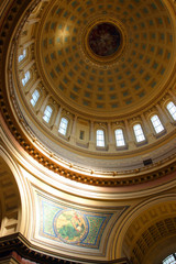 Fototapeta na wymiar Madison Wisconsin Capitol building fragment interior with lighted by penetrating sun beautiful historical mosaic wall decor Liberty on northeast side of dome and rotunda sealing with windows.