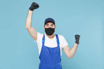 Delivery man in cap t-shirt coveralls uniform sterile face mask gloves isolated on blue background studio. Guy employee courier Service quarantine pandemic coronavirus virus covid-19 2019-ncov concept