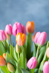 Naklejka premium Close up of fresh bouquet bunch of pink rose orange tulips in vase. Copy space. Floral background. Postcard. Selective focus. Free space.