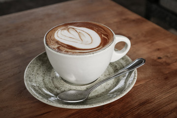 A cup of coffee with latte art on top